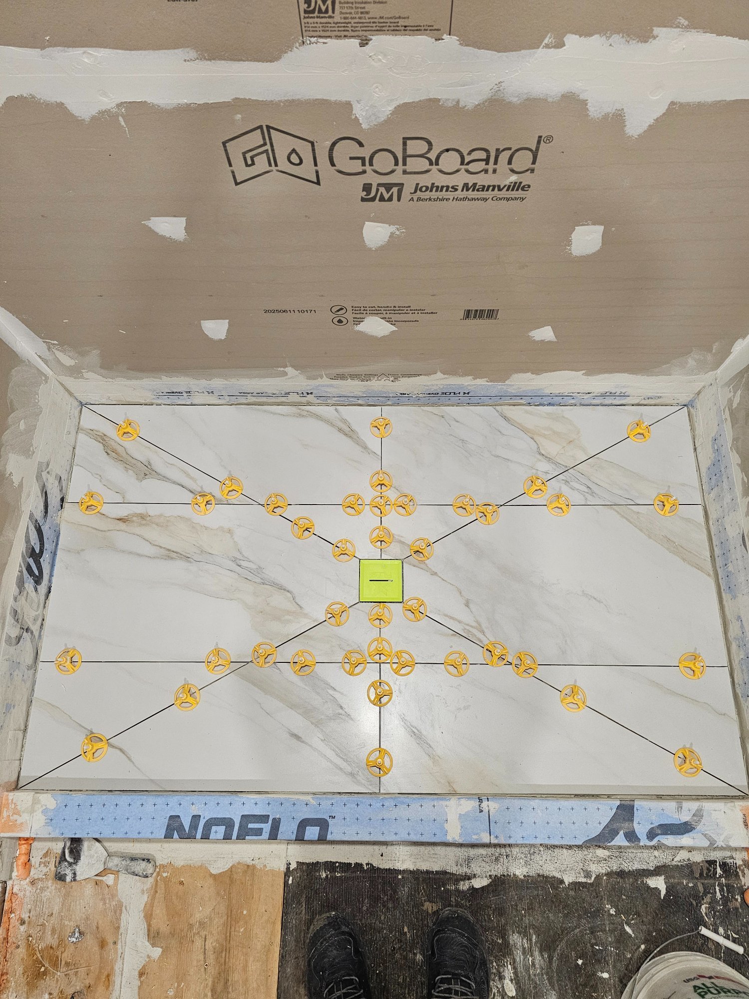 Calacatta shower floor tile with precision leveling clips — Inverness IL